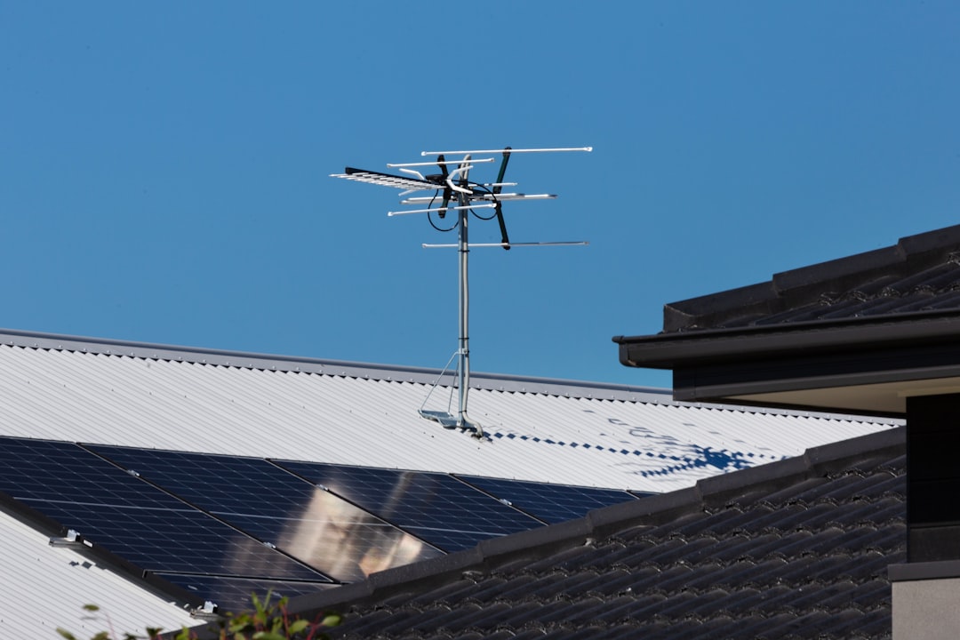 why-choose-us-img Rooftop solar panels with TV antenna.